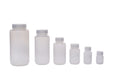 Set of white plastic bottles with silver caps on a white background